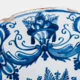 Antique Delft Plate from the early 18th century, crafted at the De Drie Porceleyne Flessies workshop, featuring the WK mark of Willem van der Kool and his widow Cornelia van Schoonhoven.