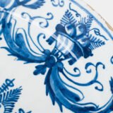 Antique Delft Plate from the early 18th century, crafted at the De Drie Porceleyne Flessies workshop, featuring the WK mark of Willem van der Kool and his widow Cornelia van Schoonhoven.