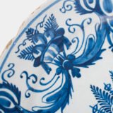 Antique Delft Plate from the early 18th century, crafted at the De Drie Porceleyne Flessies workshop, featuring the WK mark of Willem van der Kool and his widow Cornelia van Schoonhoven.