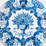 Antique Delft Plate from the early 18th century, crafted at the De Drie Porceleyne Flessies workshop, featuring the WK mark of Willem van der Kool and his widow Cornelia van Schoonhoven.