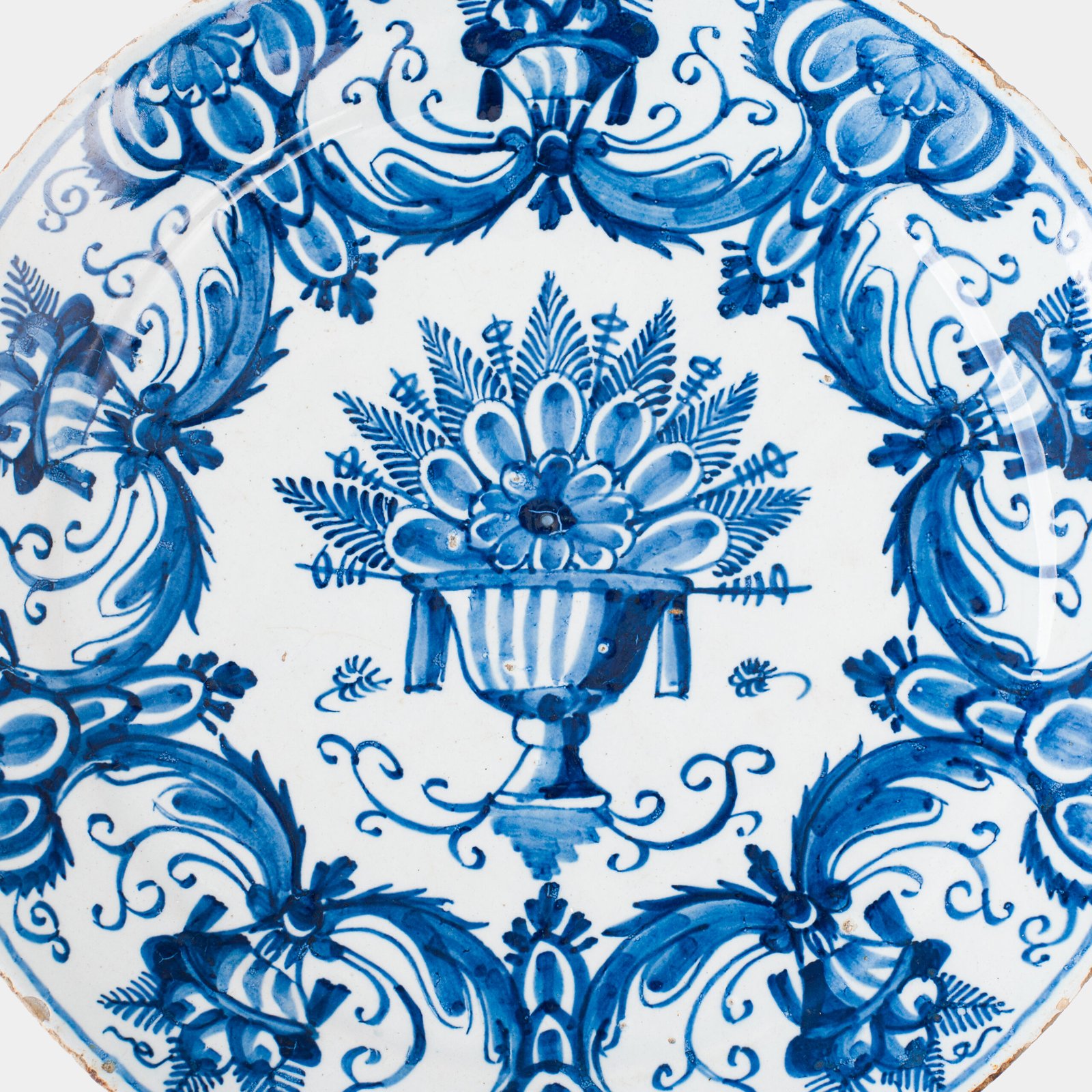 Antique Delft Plate from the early 18th century, crafted at the De Drie Porceleyne Flessies workshop, featuring the WK mark of Willem van der Kool and his widow Cornelia van Schoonhoven.