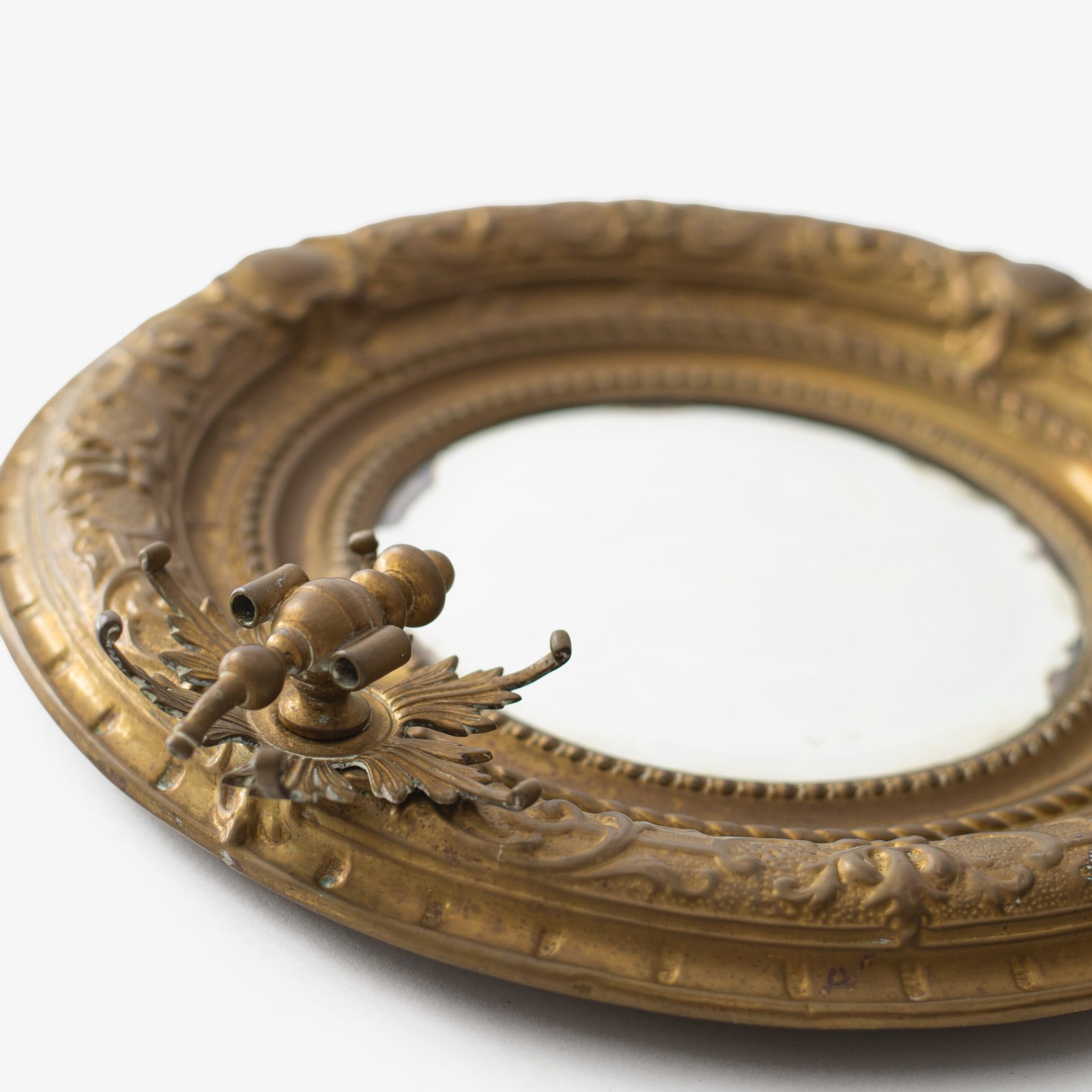 Antique Swedish Brass Mirror with repoussé Neoclassical frame and original beveled glass, 1890–1910.
