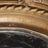 Antique Swedish Brass Mirror with repoussé Neoclassical frame and original beveled glass, 1890–1910.