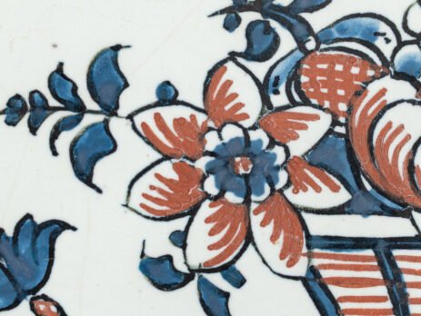 Rouen Faience Tray, an octagonal French banette from c. 1730 with two handles, a painted flower basket, and a red and blue galon rouennais border.