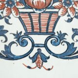 Rouen Faience Tray, an octagonal French banette from c. 1730 with two handles, a painted flower basket, and a red and blue galon rouennais border.