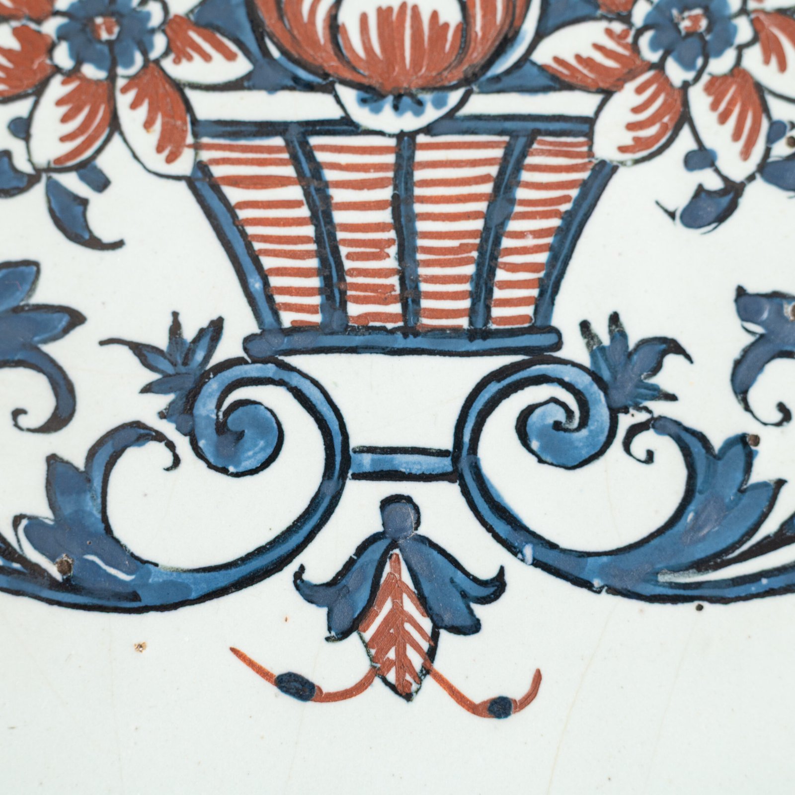 Rouen Faience Tray, an octagonal French banette from c. 1730 with two handles, a painted flower basket, and a red and blue galon rouennais border.