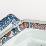 Rouen Faience Tray, an octagonal French banette from c. 1730 with two handles, a painted flower basket, and a red and blue galon rouennais border.