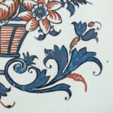 Rouen Faience Tray, an octagonal French banette from c. 1730 with two handles, a painted flower basket, and a red and blue galon rouennais border.