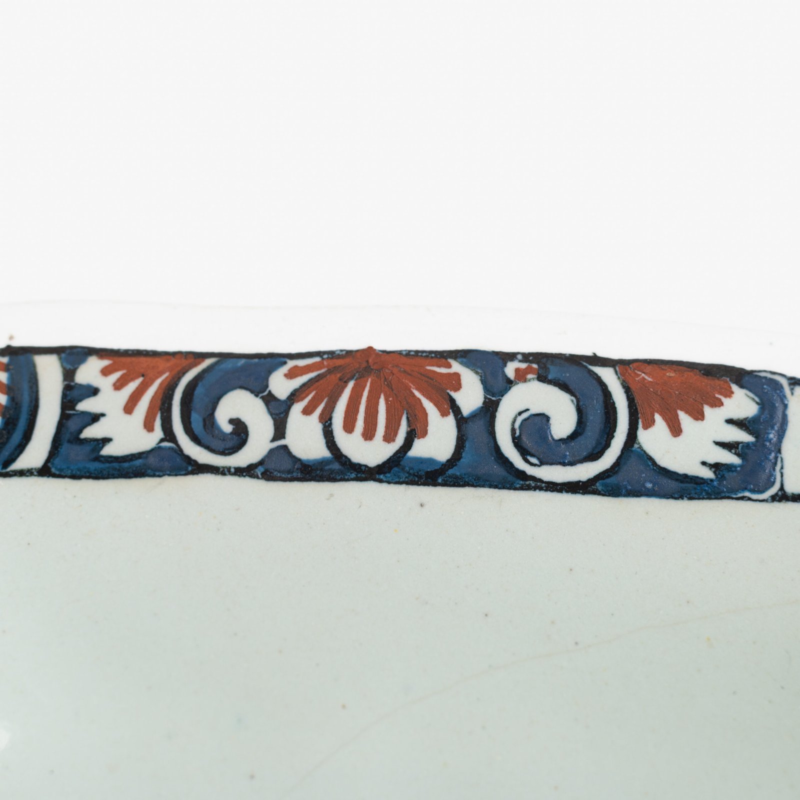 Rouen Faience Tray, an octagonal French banette from c. 1730 with two handles, a painted flower basket, and a red and blue galon rouennais border.