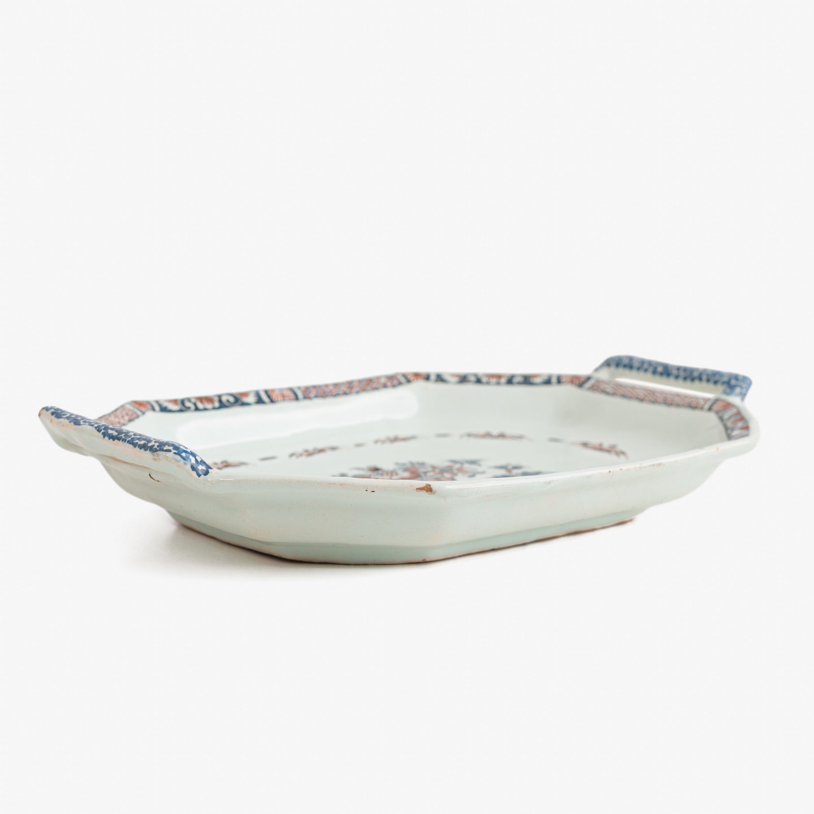 Rouen Faience Tray, an octagonal French banette from c. 1730 with two handles, a painted flower basket, and a red and blue galon rouennais border.