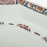 Rouen Faience Tray, an octagonal French banette from c. 1730 with two handles, a painted flower basket, and a red and blue galon rouennais border.