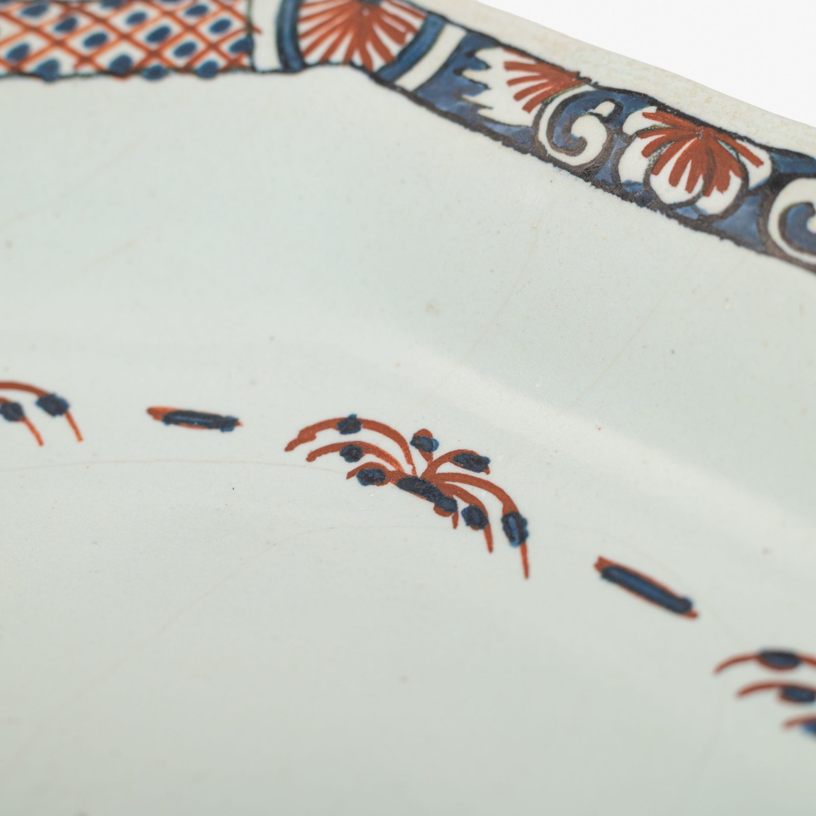 Rouen Faience Tray, an octagonal French banette from c. 1730 with two handles, a painted flower basket, and a red and blue galon rouennais border.