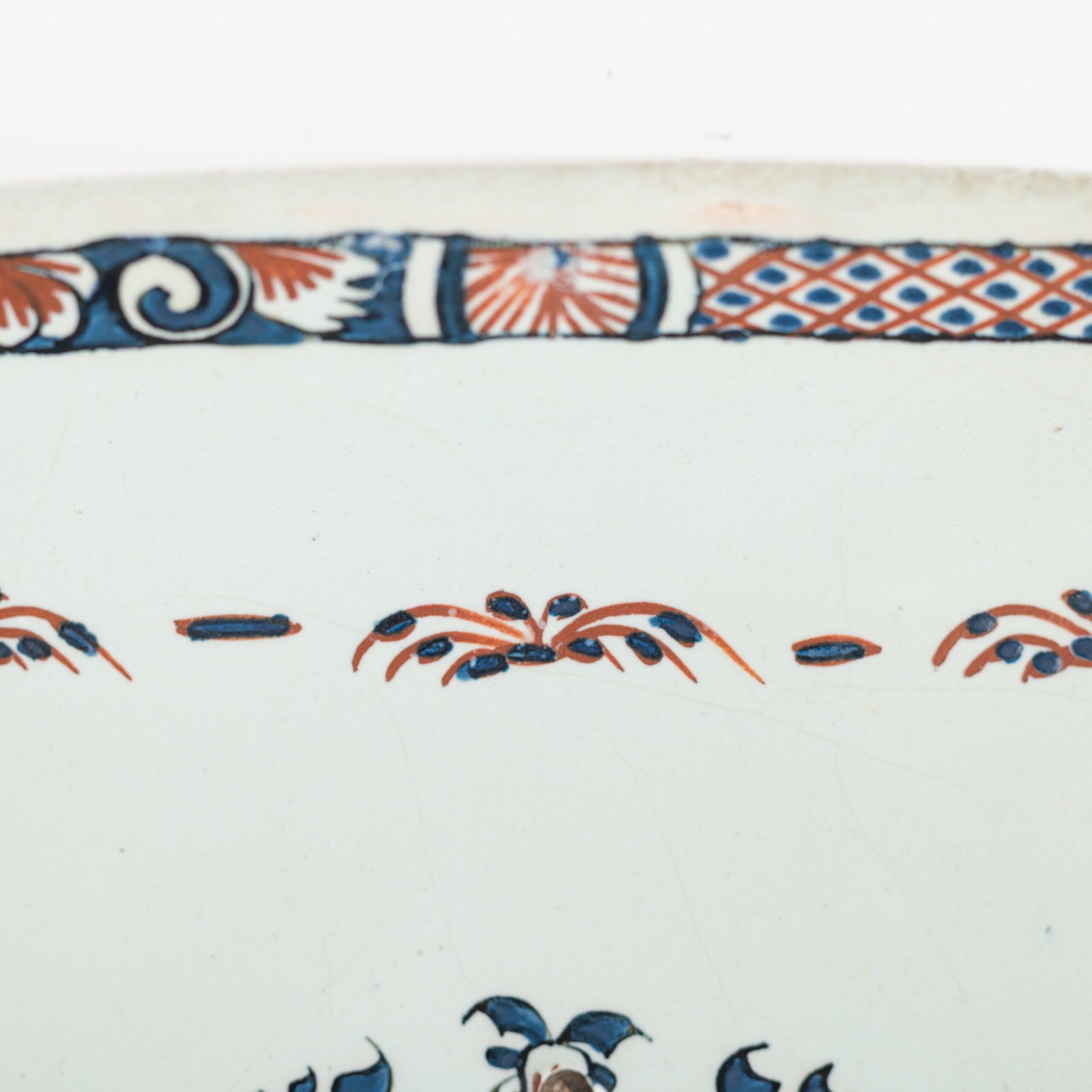 Rouen Faience Tray, an octagonal French banette from c. 1730 with two handles, a painted flower basket, and a red and blue galon rouennais border.