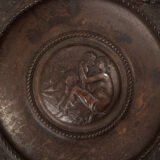Lauchhammer Cast Iron Charger, Germany, circa 1870–1900, with Renaissance Revival reliefs, a central scene of Venus and Cupid, portrait medallions and scrolling foliage.