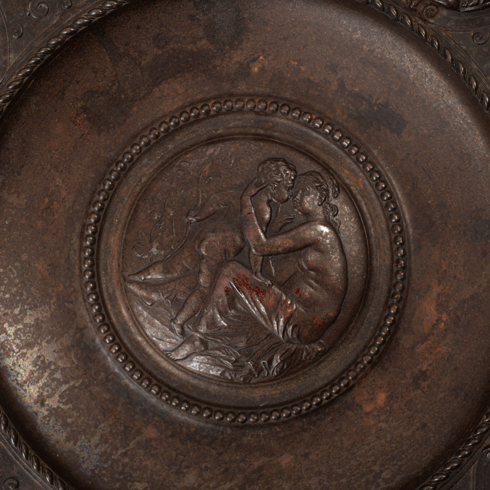 Lauchhammer Cast Iron Charger, Germany, circa 1870–1900, with Renaissance Revival reliefs, a central scene of Venus and Cupid, portrait medallions and scrolling foliage.