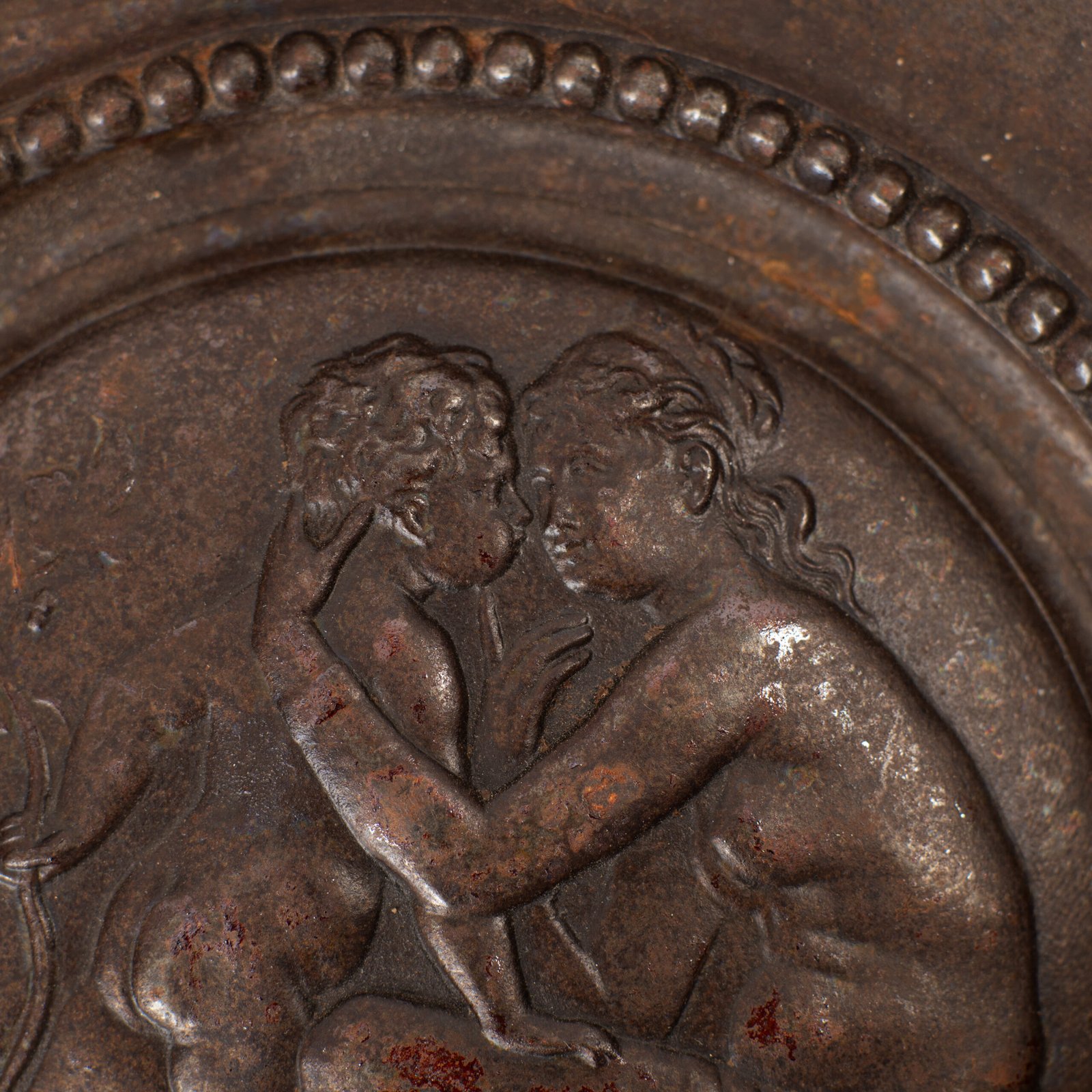 Lauchhammer Cast Iron Charger, Germany, circa 1870–1900, with Renaissance Revival reliefs, a central scene of Venus and Cupid, portrait medallions and scrolling foliage.