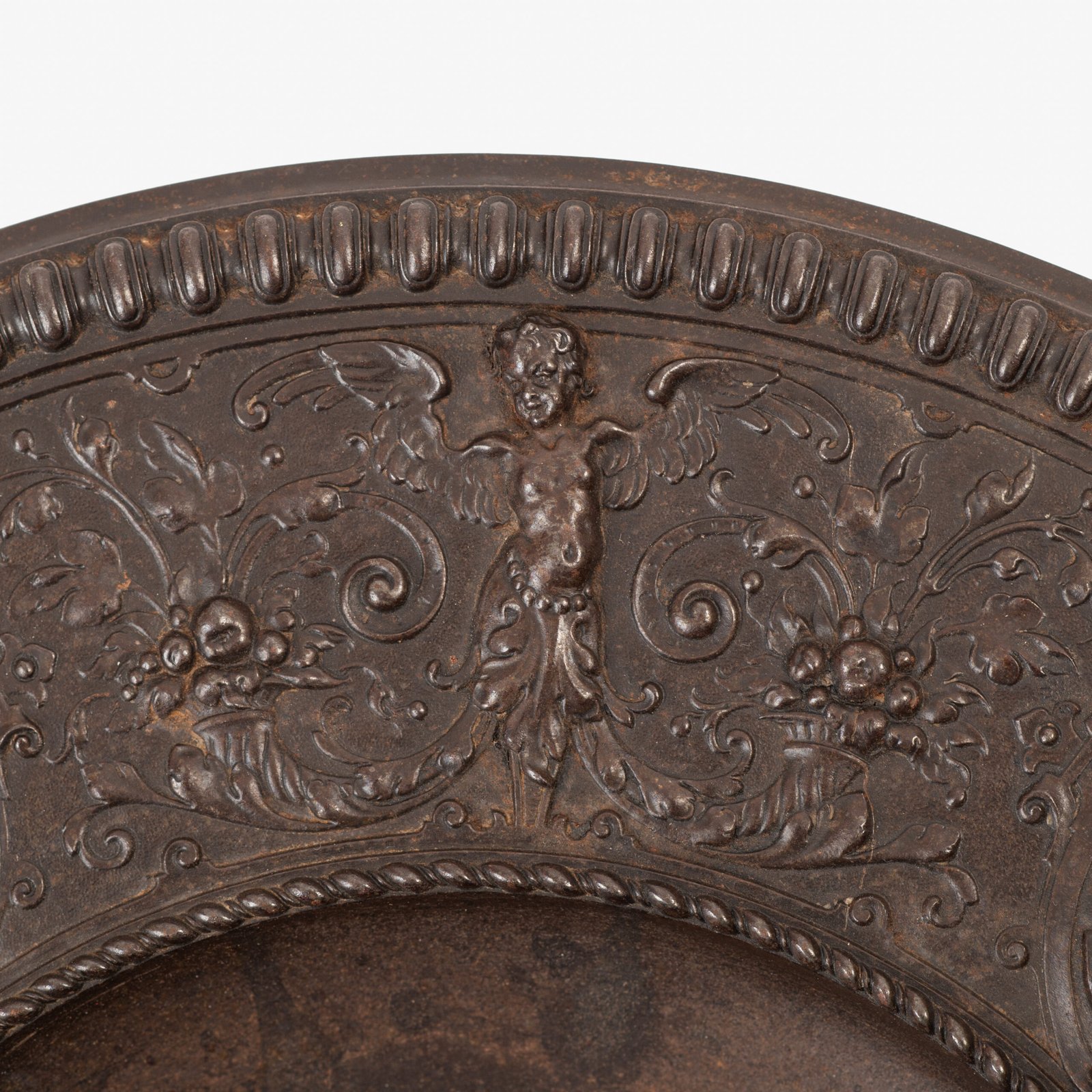 Lauchhammer Cast Iron Charger, Germany, circa 1870–1900, with Renaissance Revival reliefs, a central scene of Venus and Cupid, portrait medallions and scrolling foliage.
