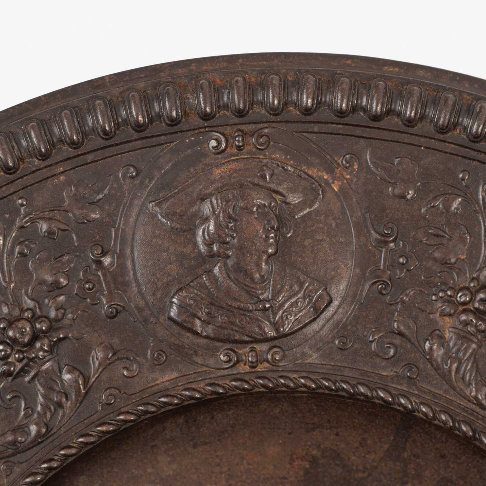 Lauchhammer Cast Iron Charger, Germany, circa 1870–1900, with Renaissance Revival reliefs, a central scene of Venus and Cupid, portrait medallions and scrolling foliage.