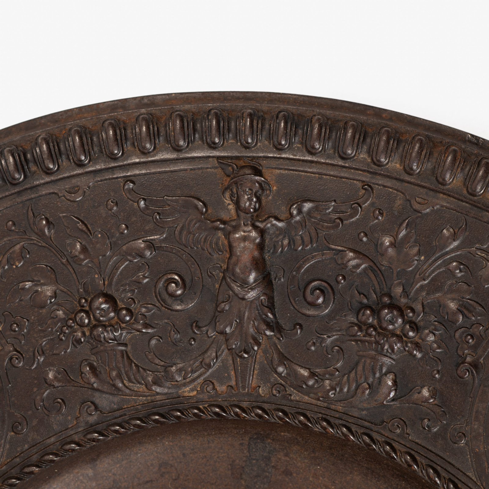 Lauchhammer Cast Iron Charger, Germany, circa 1870–1900, with Renaissance Revival reliefs, a central scene of Venus and Cupid, portrait medallions and scrolling foliage.