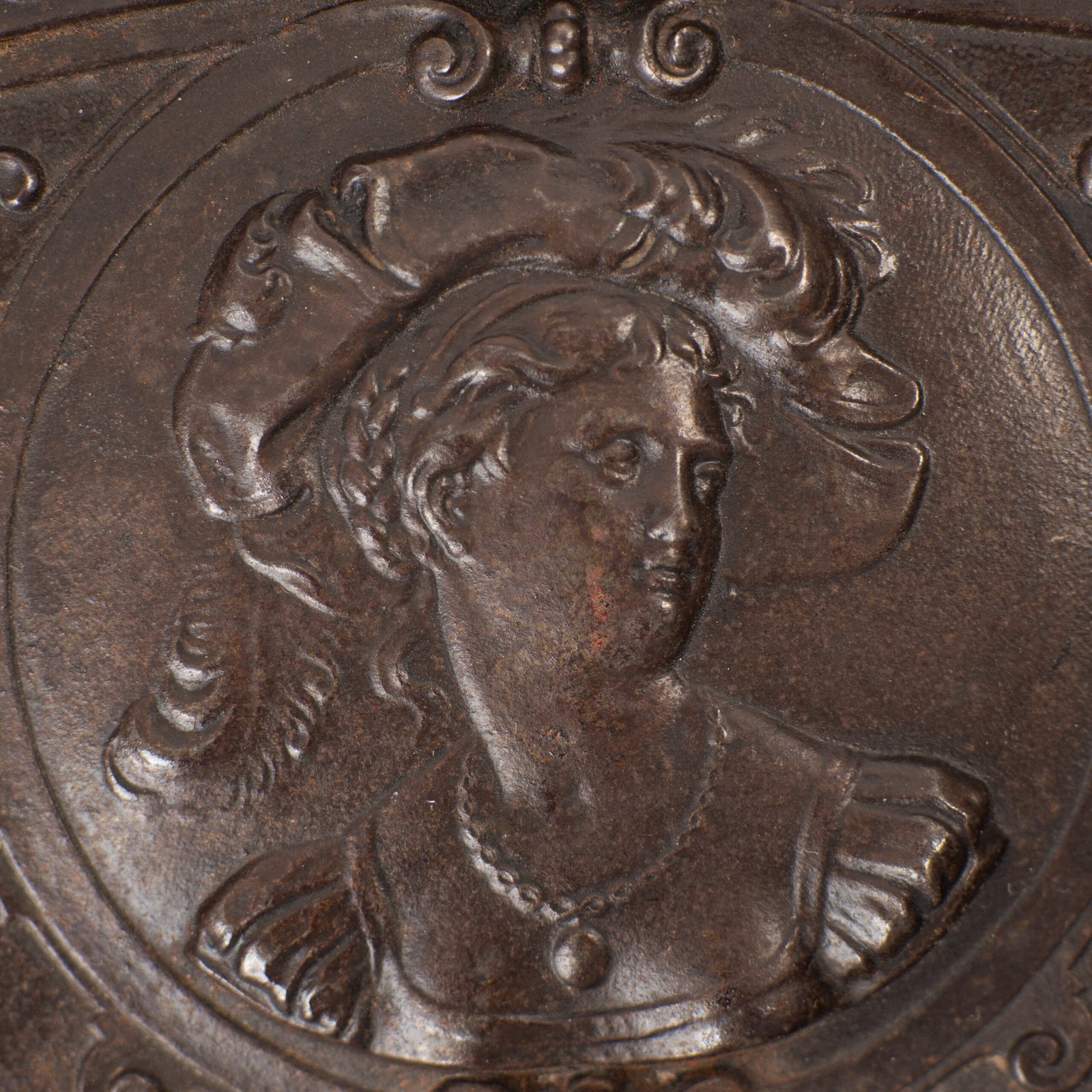 Lauchhammer Cast Iron Charger, Germany, circa 1870–1900, with Renaissance Revival reliefs, a central scene of Venus and Cupid, portrait medallions and scrolling foliage.