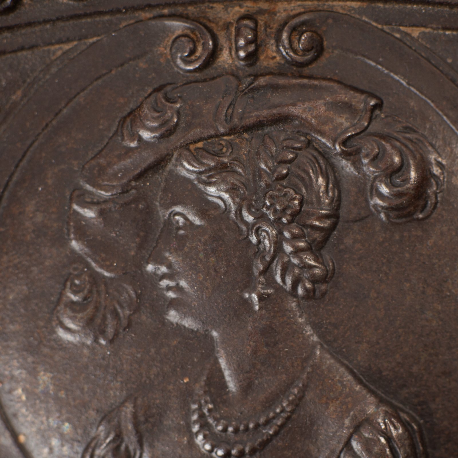 Lauchhammer Cast Iron Charger, Germany, circa 1870–1900, with Renaissance Revival reliefs, a central scene of Venus and Cupid, portrait medallions and scrolling foliage.