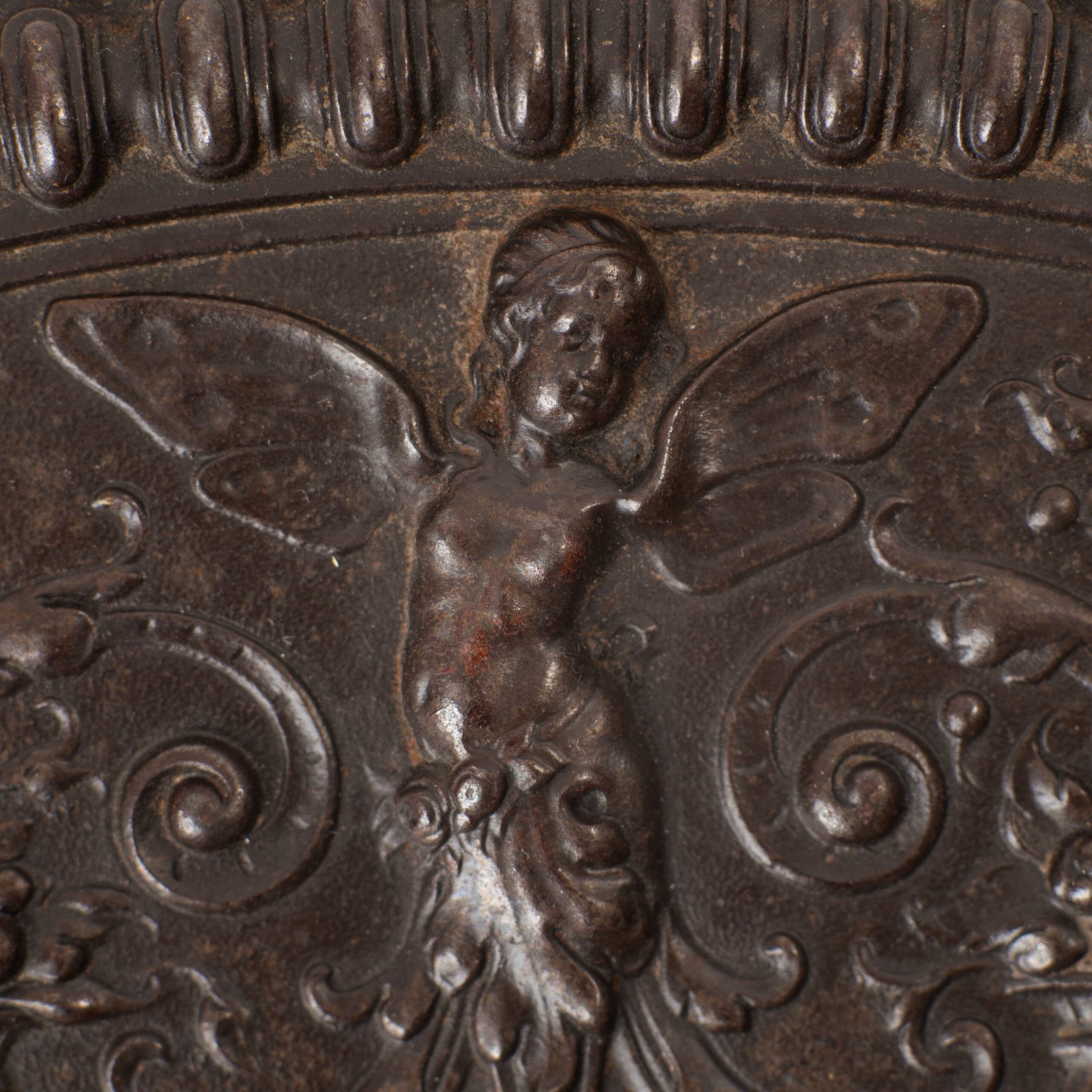 Lauchhammer Cast Iron Charger, Germany, circa 1870–1900, with Renaissance Revival reliefs, a central scene of Venus and Cupid, portrait medallions and scrolling foliage.