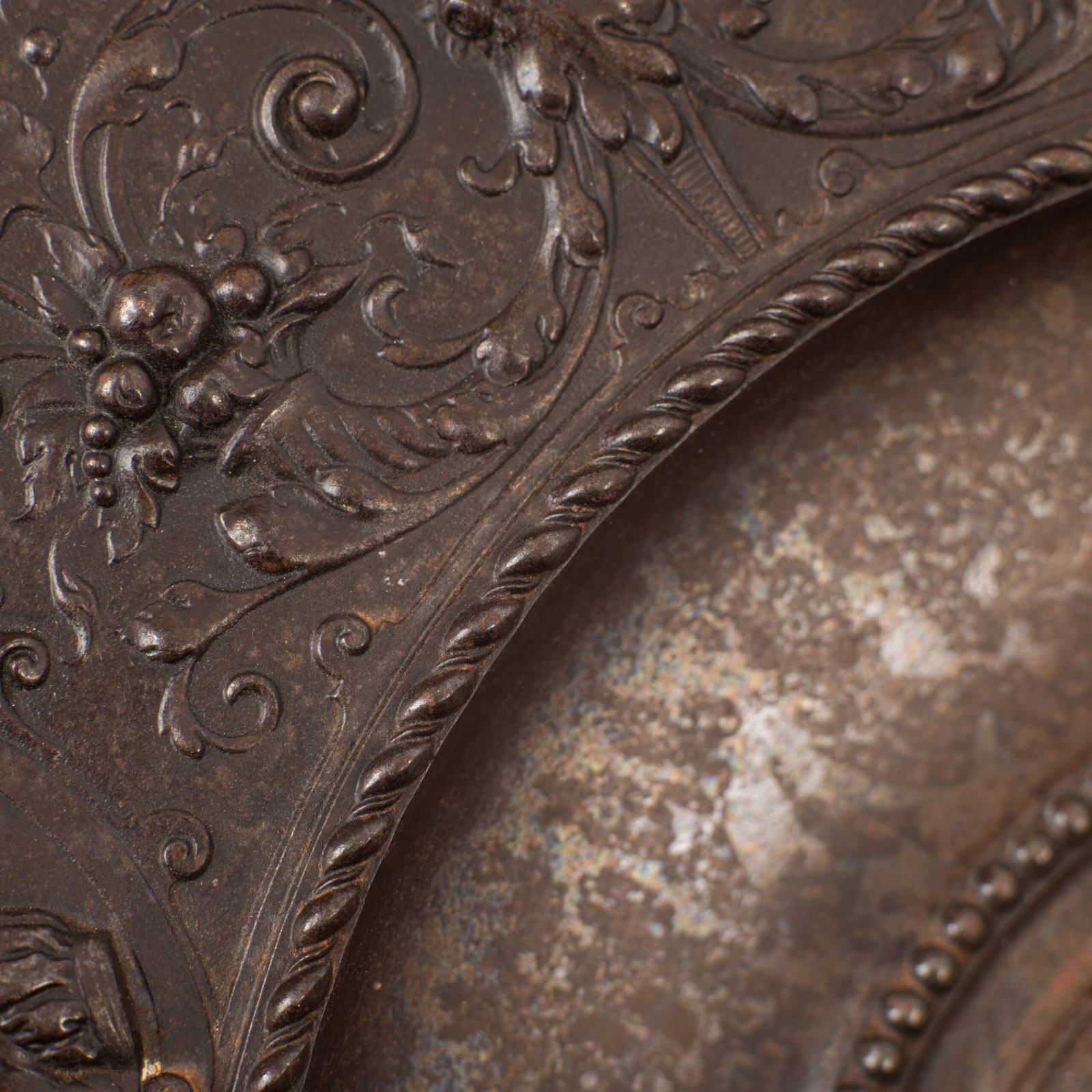 Lauchhammer Cast Iron Charger, Germany, circa 1870–1900, with Renaissance Revival reliefs, a central scene of Venus and Cupid, portrait medallions and scrolling foliage.