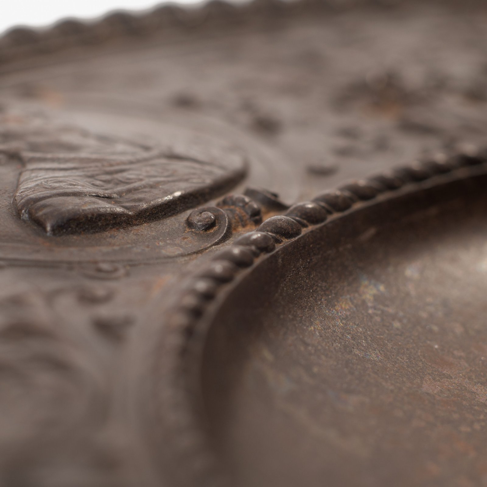 Lauchhammer Cast Iron Charger, Germany, circa 1870–1900, with Renaissance Revival reliefs, a central scene of Venus and Cupid, portrait medallions and scrolling foliage.