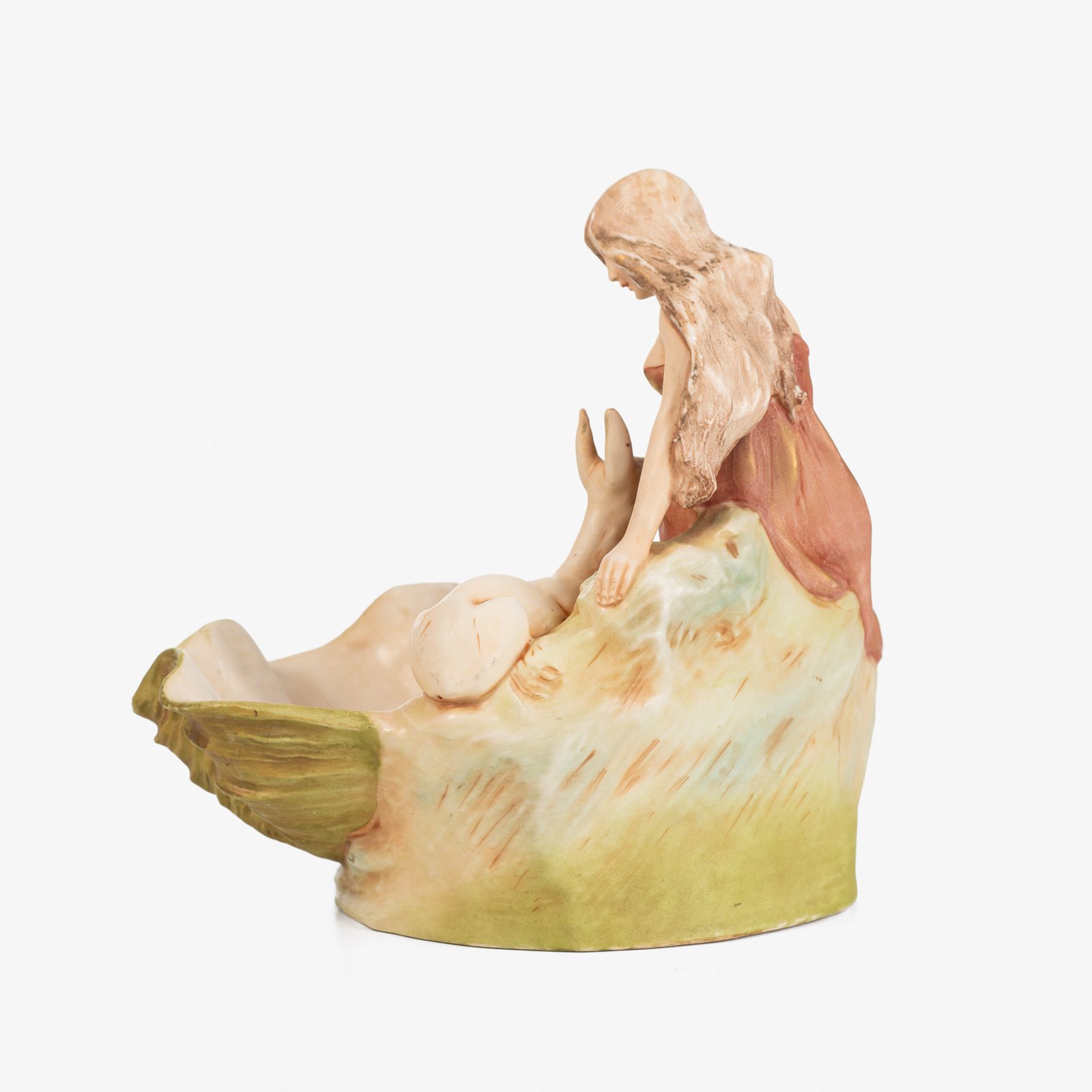 Royal Dux Art Nouveau porcelain centerpiece with a seated maiden and fawn beside a green shell-shaped bowl, hand-painted with gilt highlights, circa 1920–1930.