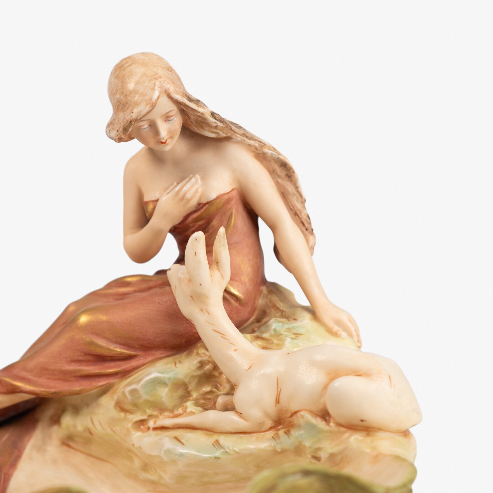 Royal Dux Art Nouveau porcelain centerpiece with a seated maiden and fawn beside a green shell-shaped bowl, hand-painted with gilt highlights, circa 1920–1930.