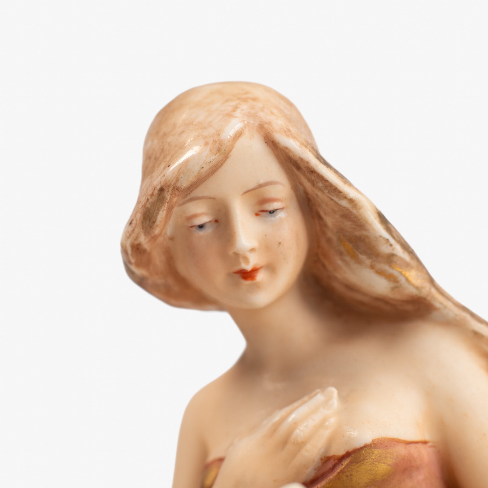 Royal Dux Art Nouveau porcelain centerpiece with a seated maiden and fawn beside a green shell-shaped bowl, hand-painted with gilt highlights, circa 1920–1930.