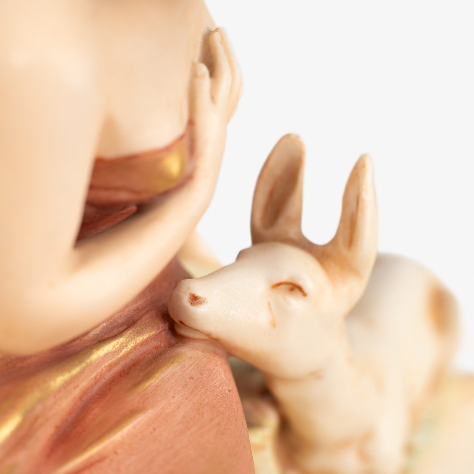Royal Dux Art Nouveau porcelain centerpiece with a seated maiden and fawn beside a green shell-shaped bowl, hand-painted with gilt highlights, circa 1920–1930.