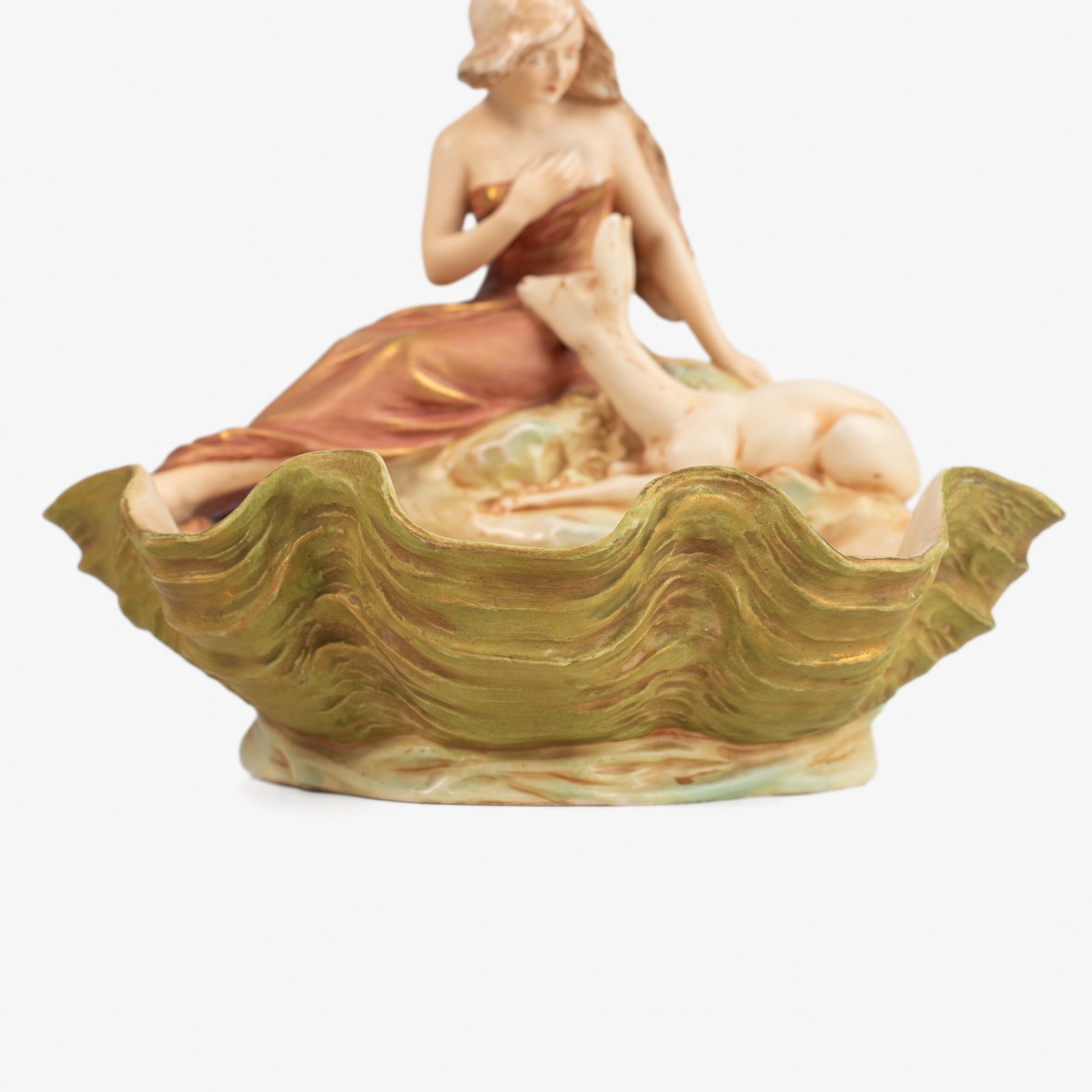 Royal Dux Art Nouveau porcelain centerpiece with a seated maiden and fawn beside a green shell-shaped bowl, hand-painted with gilt highlights, circa 1920–1930.