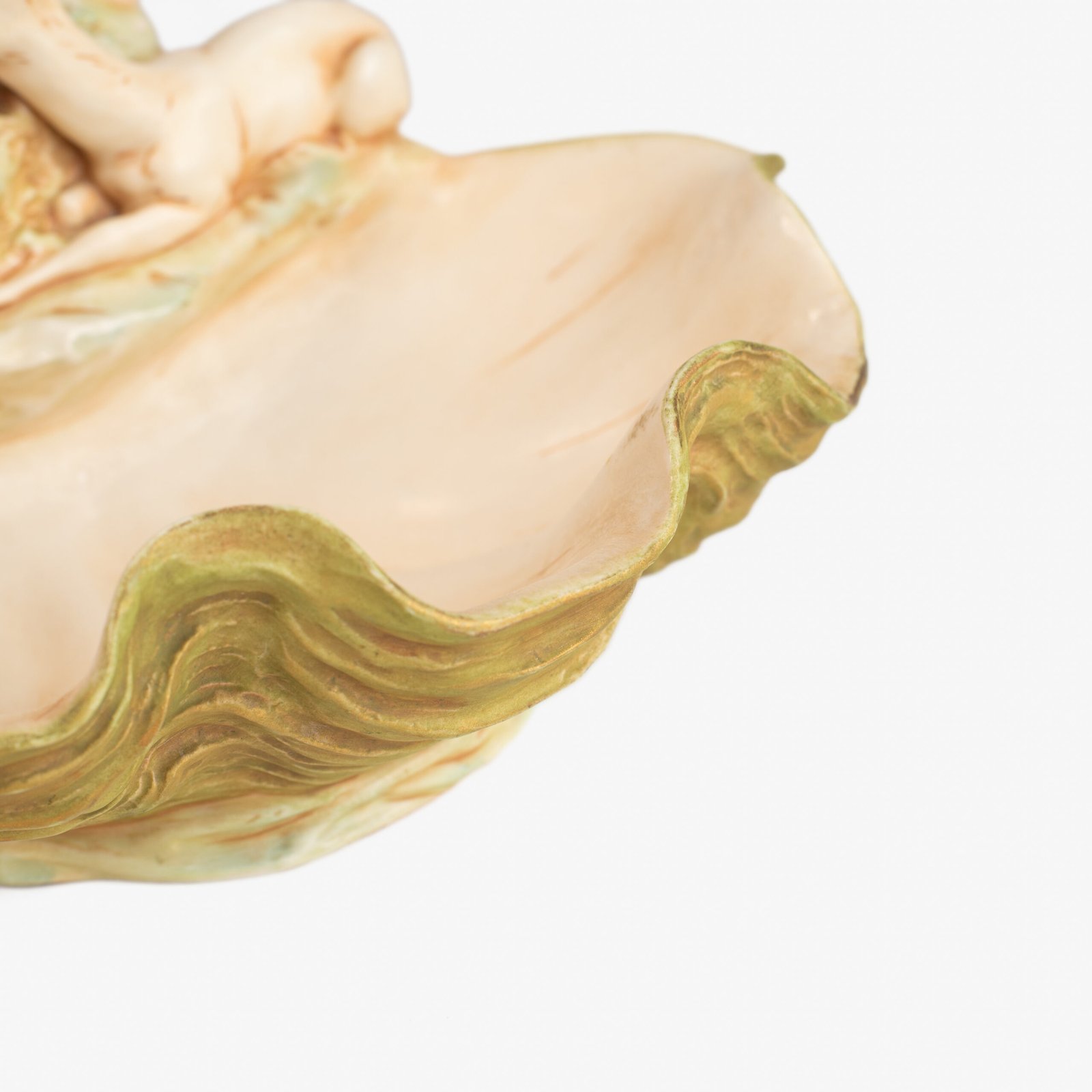 Royal Dux Art Nouveau porcelain centerpiece with a seated maiden and fawn beside a green shell-shaped bowl, hand-painted with gilt highlights, circa 1920–1930.
