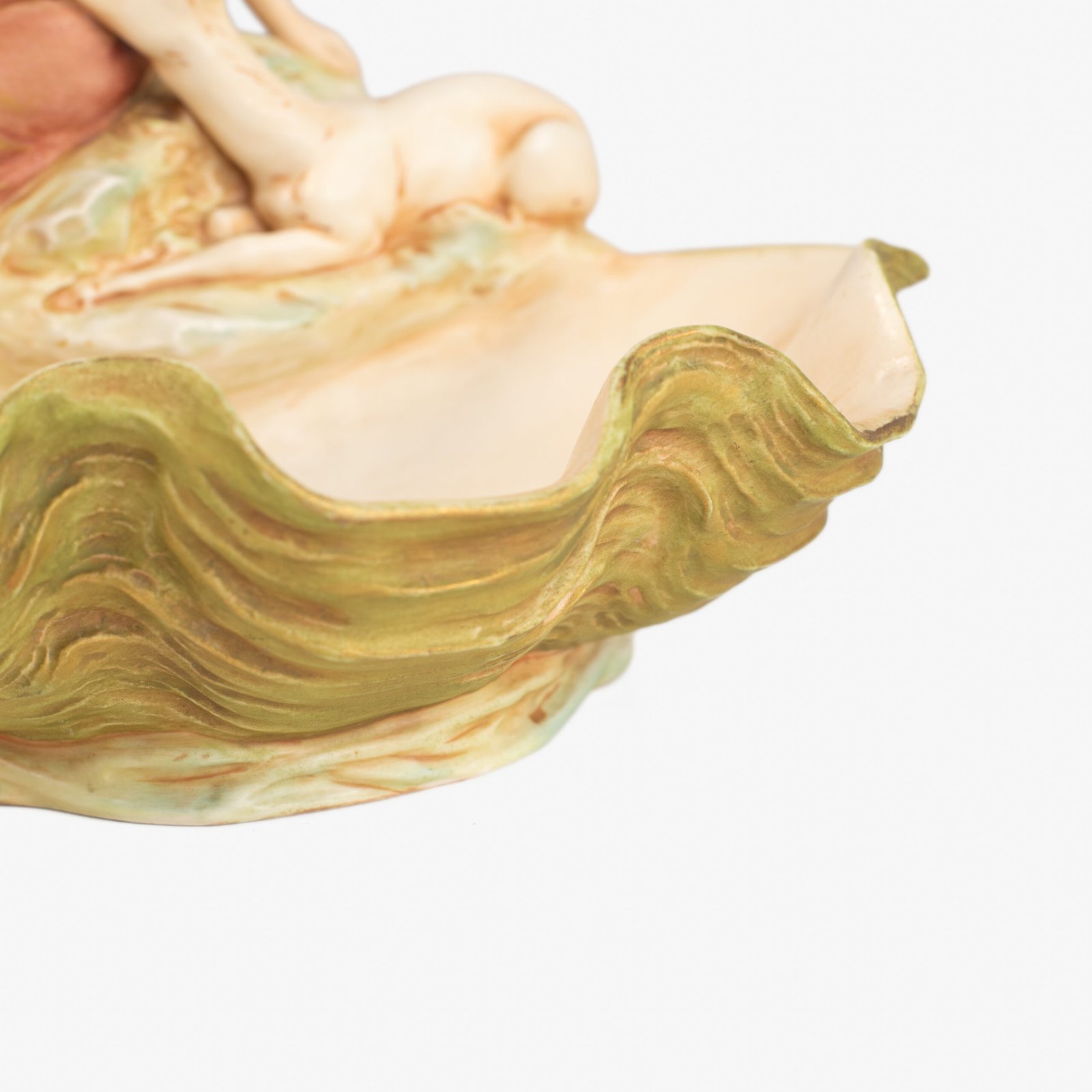 Royal Dux Art Nouveau porcelain centerpiece with a seated maiden and fawn beside a green shell-shaped bowl, hand-painted with gilt highlights, circa 1920–1930.