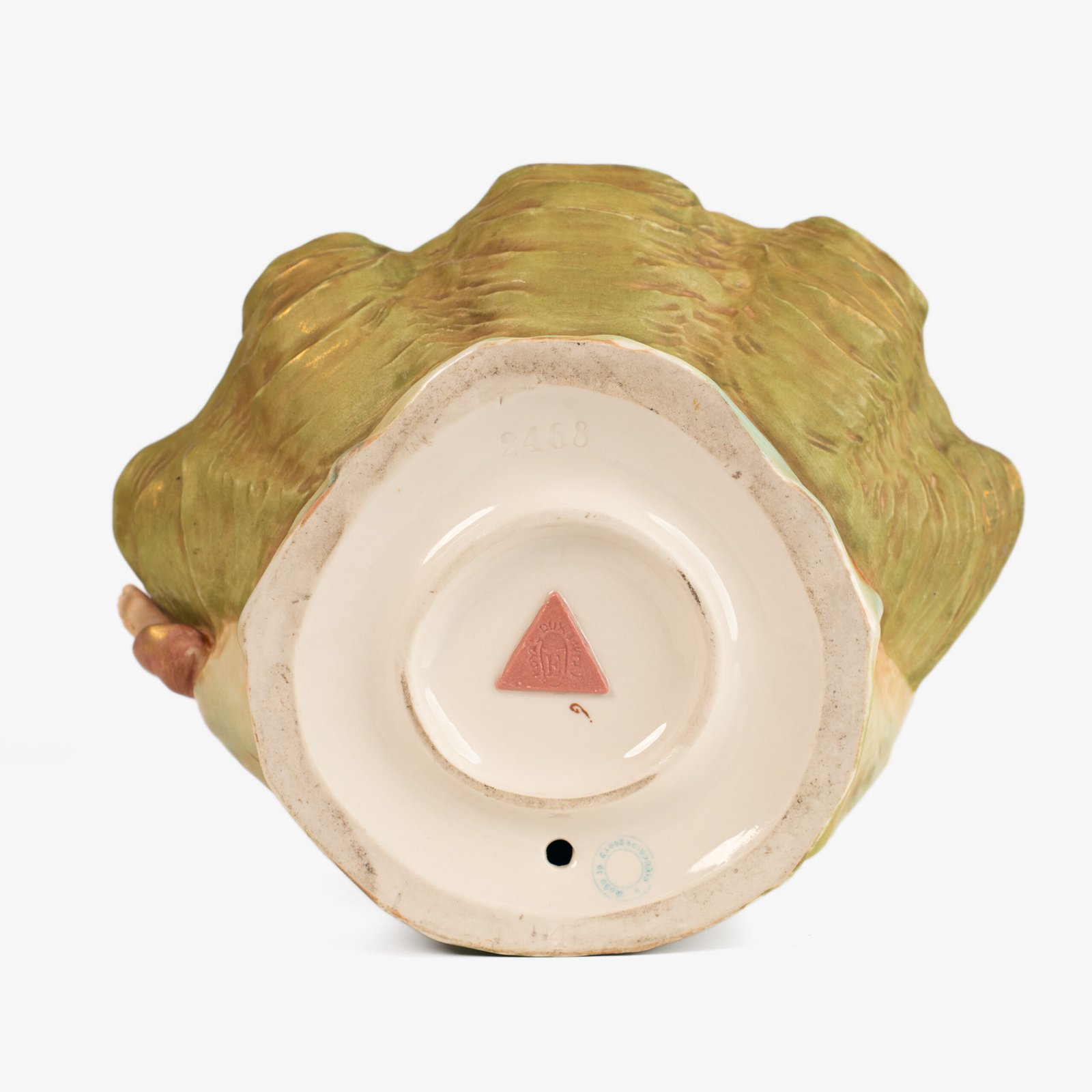 Royal Dux Art Nouveau porcelain centerpiece with a seated maiden and fawn beside a green shell-shaped bowl, hand-painted with gilt highlights, circa 1920–1930.