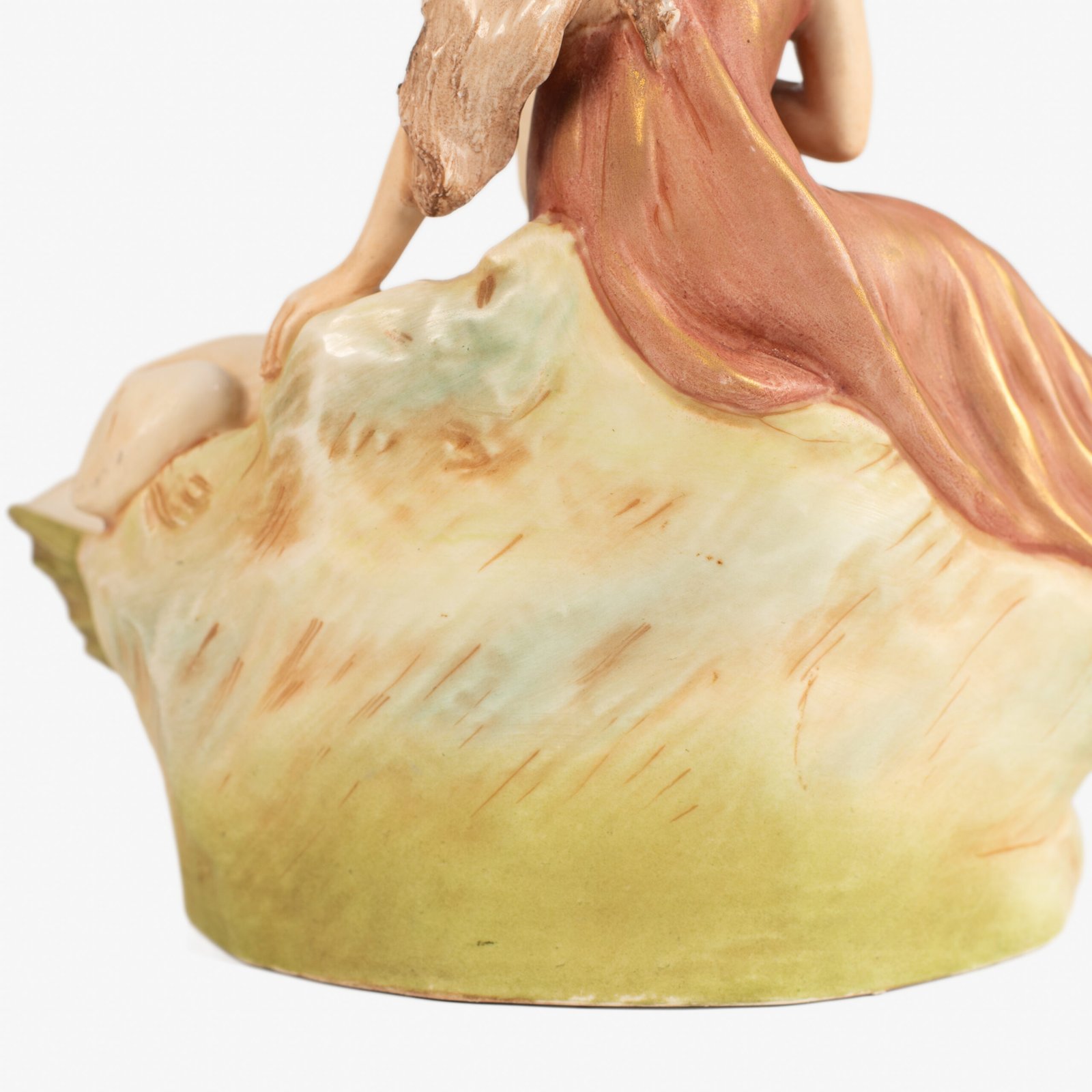 Royal Dux Art Nouveau porcelain centerpiece with a seated maiden and fawn beside a green shell-shaped bowl, hand-painted with gilt highlights, circa 1920–1930.