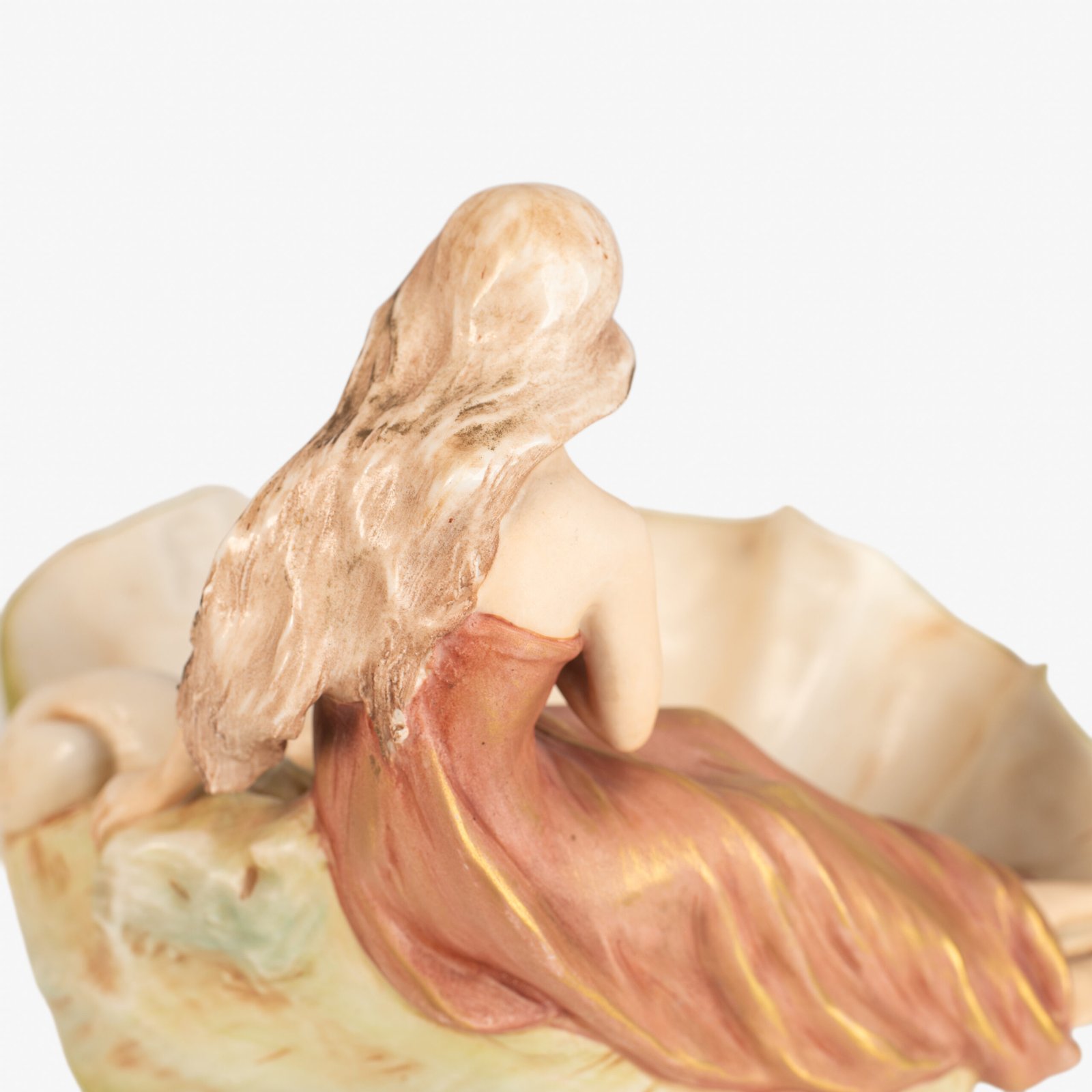 Royal Dux Art Nouveau porcelain centerpiece with a seated maiden and fawn beside a green shell-shaped bowl, hand-painted with gilt highlights, circa 1920–1930.