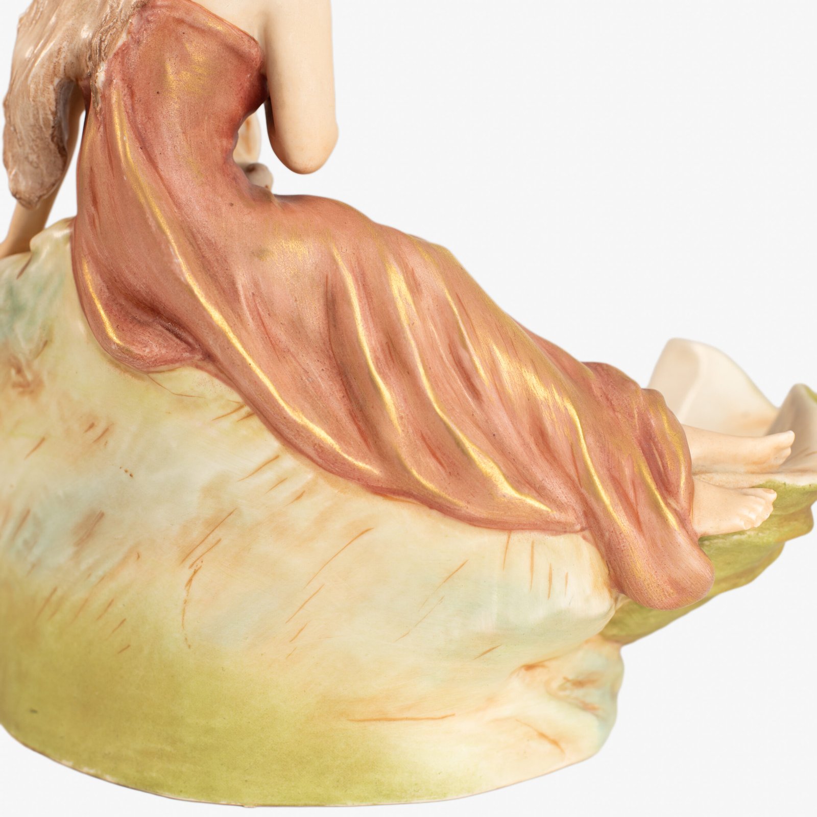 Royal Dux Art Nouveau porcelain centerpiece with a seated maiden and fawn beside a green shell-shaped bowl, hand-painted with gilt highlights, circa 1920–1930.