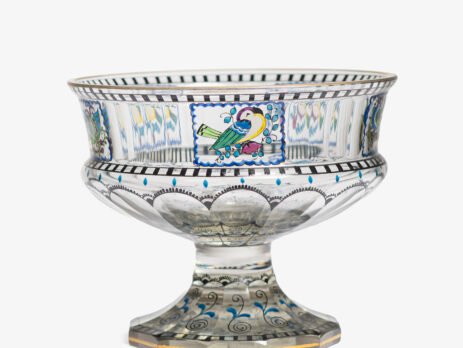 Bohemian Glass Compote, c. 1915, with hand-enamelled birds in scalloped blue panels, geometric glass cutting, gilt rim and a faceted foot decorated with black scrolls and blue leaves.