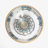 Bohemian Glass Compote, c. 1915, with hand-enamelled birds in scalloped blue panels, geometric glass cutting, gilt rim and a faceted foot decorated with black scrolls and blue leaves.