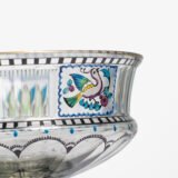 Bohemian Glass Compote, c. 1915, with hand-enamelled birds in scalloped blue panels, geometric glass cutting, gilt rim and a faceted foot decorated with black scrolls and blue leaves.