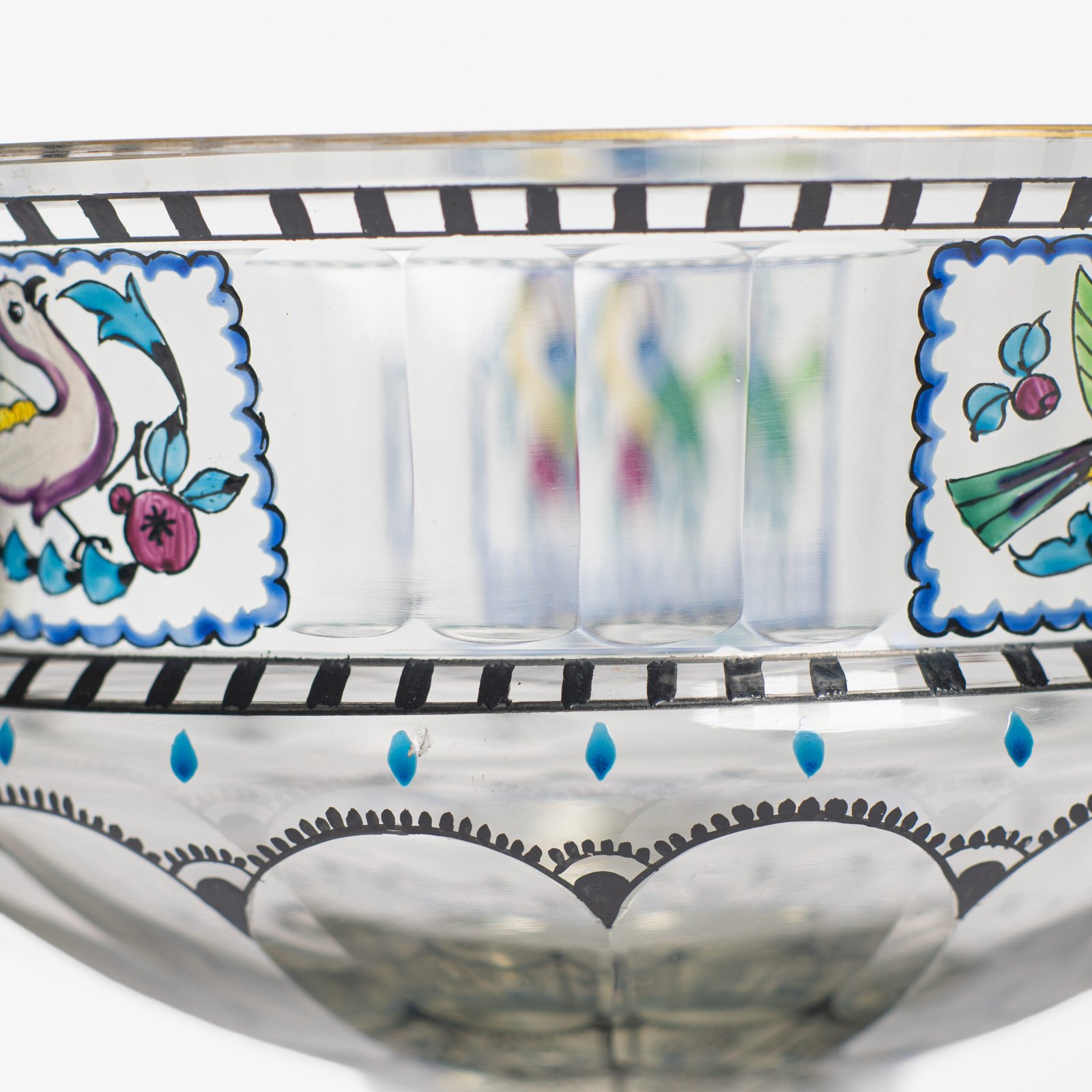 Bohemian Glass Compote, c. 1915, with hand-enamelled birds in scalloped blue panels, geometric glass cutting, gilt rim and a faceted foot decorated with black scrolls and blue leaves.