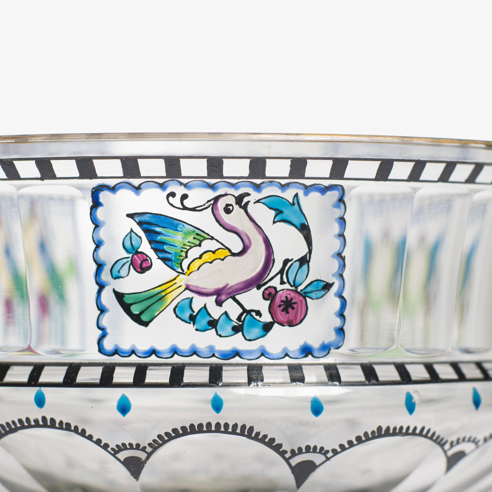 Bohemian Glass Compote, c. 1915, with hand-enamelled birds in scalloped blue panels, geometric glass cutting, gilt rim and a faceted foot decorated with black scrolls and blue leaves.