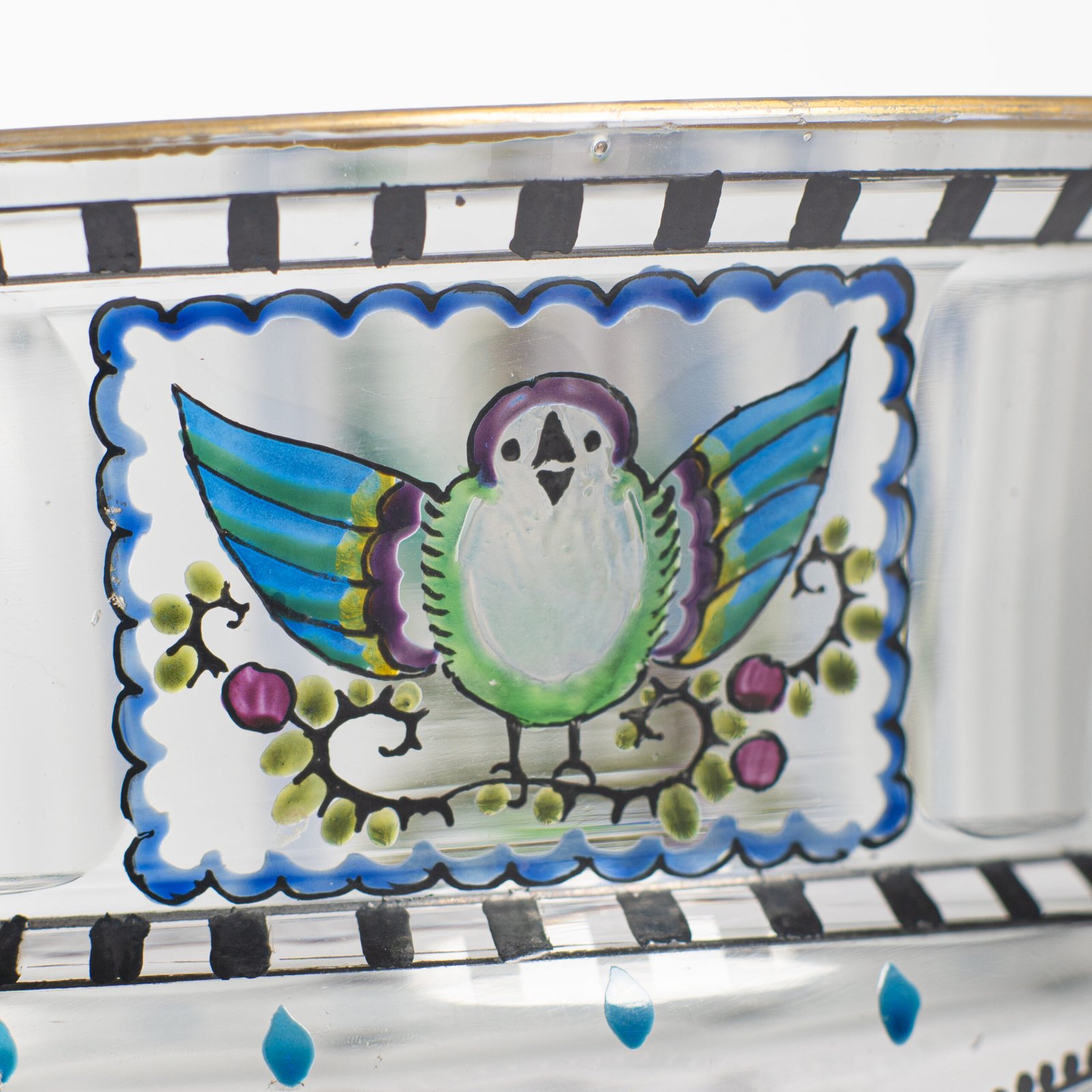 Bohemian Glass Compote, c. 1915, with hand-enamelled birds in scalloped blue panels, geometric glass cutting, gilt rim and a faceted foot decorated with black scrolls and blue leaves.