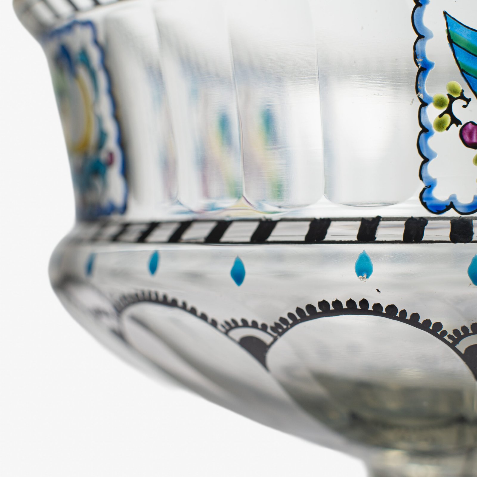 Bohemian Glass Compote, c. 1915, with hand-enamelled birds in scalloped blue panels, geometric glass cutting, gilt rim and a faceted foot decorated with black scrolls and blue leaves.