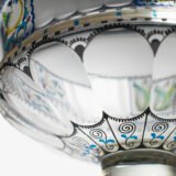 Bohemian Glass Compote, c. 1915, with hand-enamelled birds in scalloped blue panels, geometric glass cutting, gilt rim and a faceted foot decorated with black scrolls and blue leaves.
