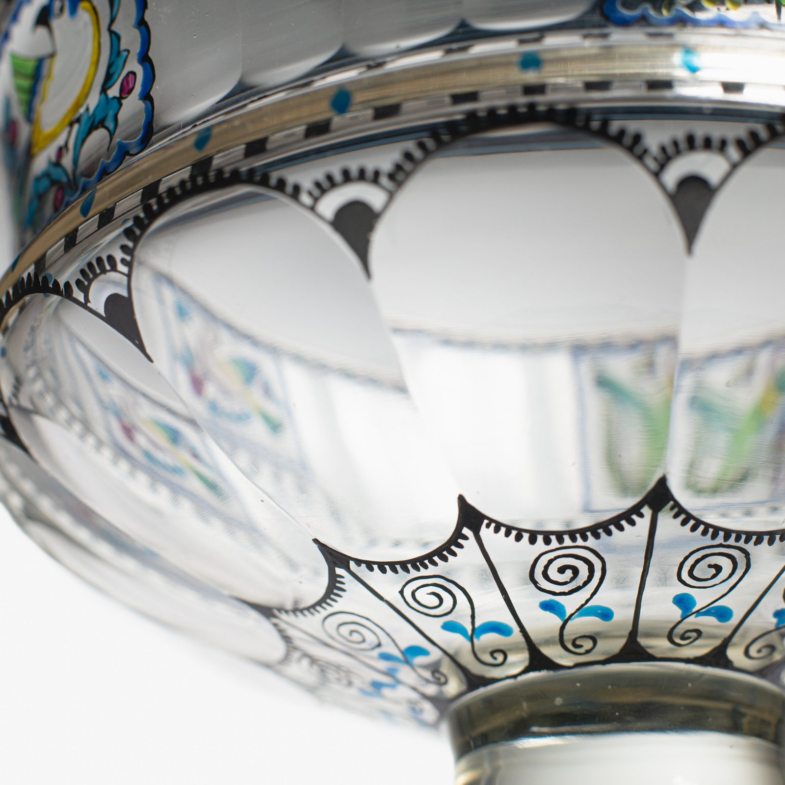 Bohemian Glass Compote, c. 1915, with hand-enamelled birds in scalloped blue panels, geometric glass cutting, gilt rim and a faceted foot decorated with black scrolls and blue leaves.