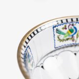 Bohemian Glass Compote, c. 1915, with hand-enamelled birds in scalloped blue panels, geometric glass cutting, gilt rim and a faceted foot decorated with black scrolls and blue leaves.