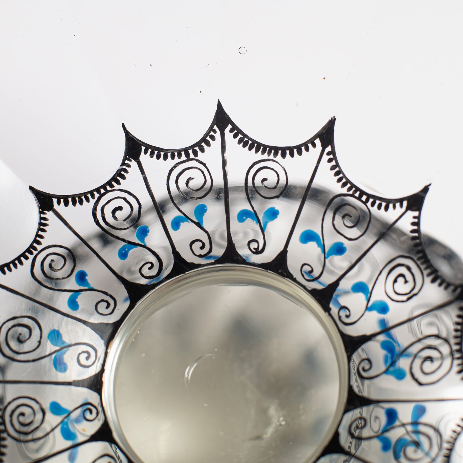 Bohemian Glass Compote, c. 1915, with hand-enamelled birds in scalloped blue panels, geometric glass cutting, gilt rim and a faceted foot decorated with black scrolls and blue leaves.